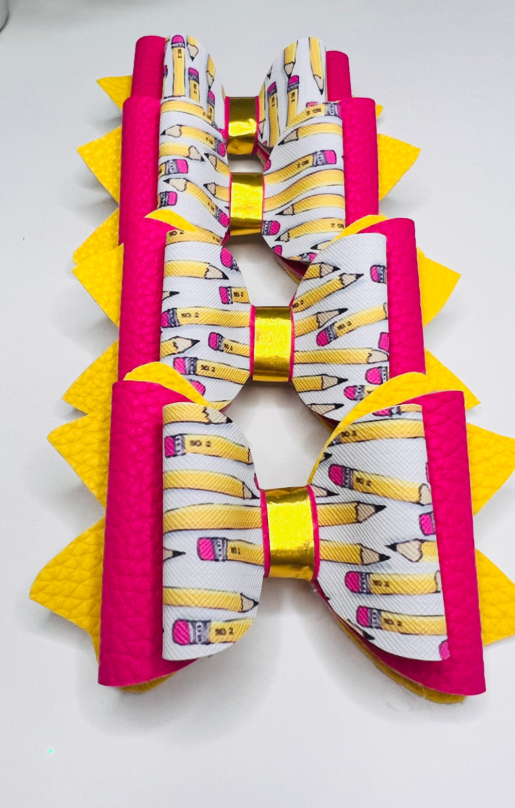 Pink and yellow pencil bow